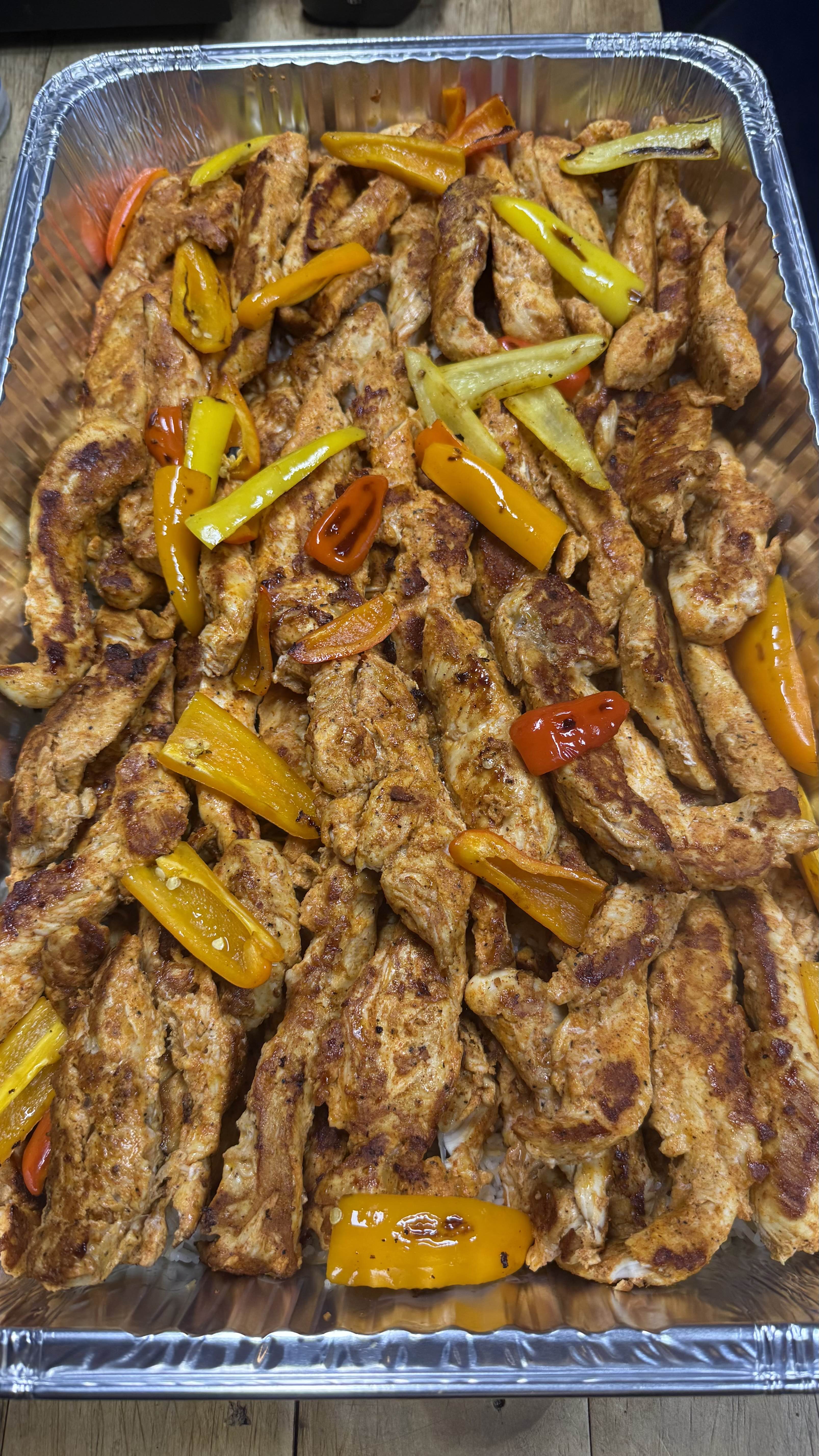 Seasoned grilled chicken strips with colorful roasted peppers
