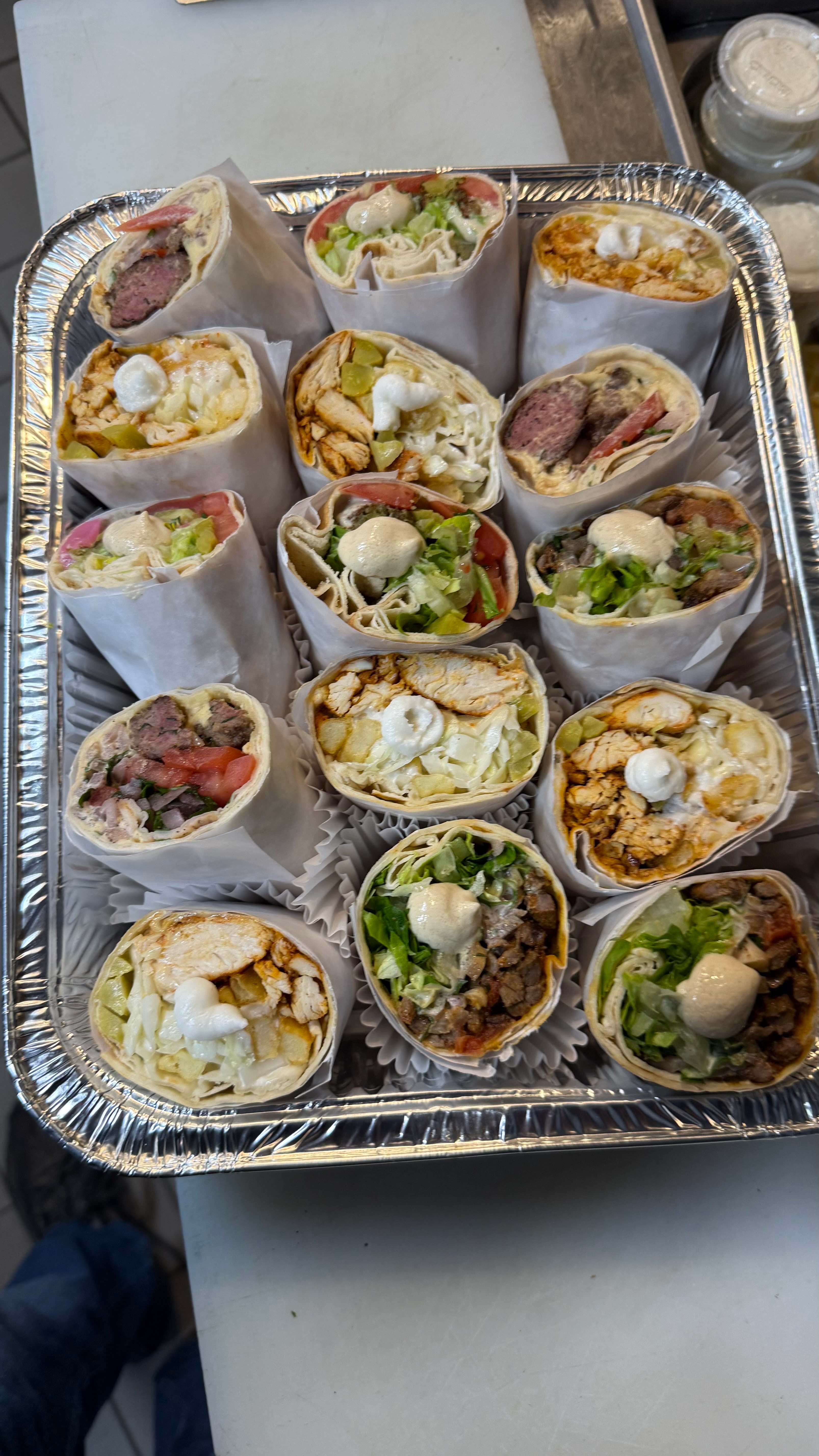 Assorted Lebanese wraps with chicken, beef, and falafel topped with garlic sauce