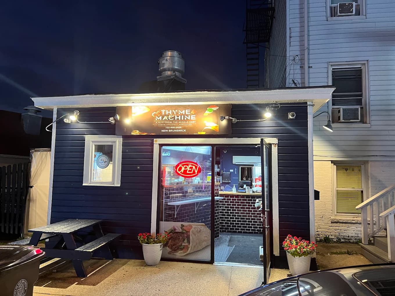 Thyme Machine restaurant exterior at night with warm inviting lighting